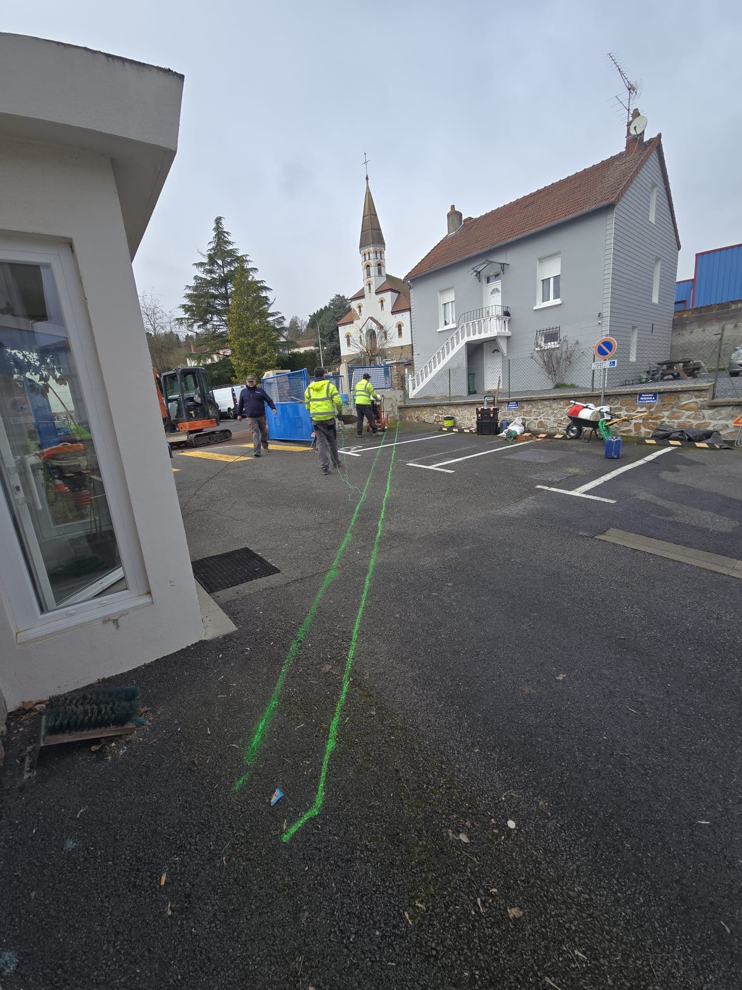 Marquage au sol vert sur place de village, reperage du fourreau et du regard